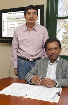 Professor Mahinda Siriwardana (seated) and Dr Xianming Meng.