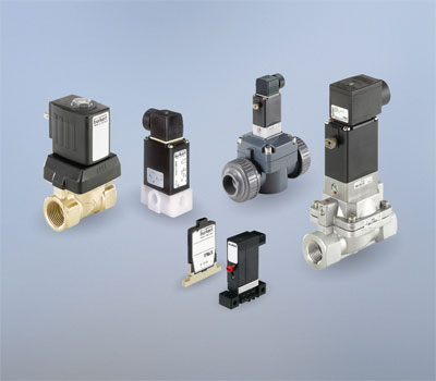  Solenoid valves showing various material options; clockwise from left: types 6213, 0124, 0142, 5282, 6144, 6650.