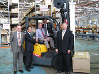 NTP’s Damien Garvey (left), Nick Perdelis (behind) and John Naffine (right) together with Mr. Ishiki of the TCM Corporation and Chris Chilcott (seated) from Electrolux with the 5000th TCM unit.
