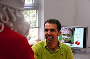 The leader of CSIRO's facial expression recognition technology research team, Dr Simon Lucey, welcoming Santa to the team's research facilities in Sydney. Image by CSIRO.
