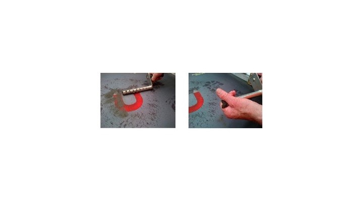 Magnet cleaning tool being used to clean and retain the collected magnetic fragments from the mat surface.