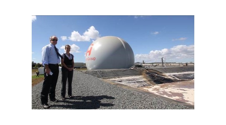 Michael Bambridge, Managing Director of CST Wastewater Solutions and Kelly Hawkins, Biogas Technician at Oakey Beef Exports, with the giant green energy orb in the background