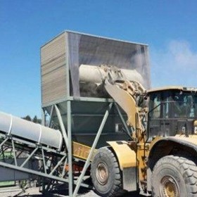 Dry fog application in surge and front end loader hoppers