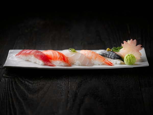 beautifully arranged sushi pieces on a plate, featuring vibrant colors and elegant presentation.