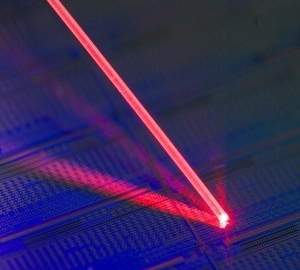 Laser light addressing a single erbium atom in a silicon chip.