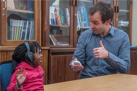 De Wet Swanepoel, PhD, testing a 4-year-old with hearScreen, a smartphone app. (Image: University of Pretoria)