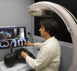 Graduate student Ali Uneri demonstrates the new surgical guidance system. (Image: Johns Hopkins)