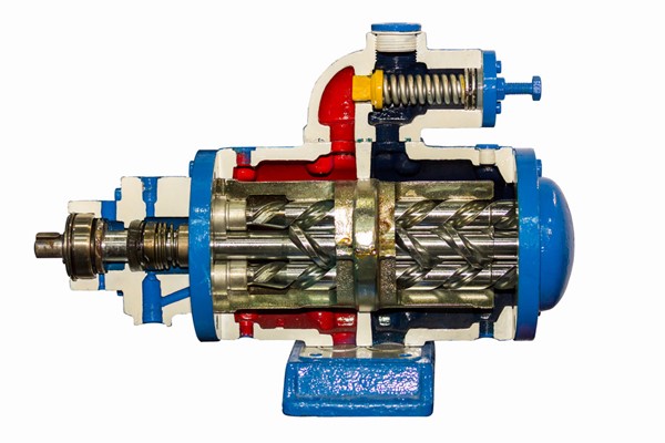 Cross-section of a mechanical component with visible gears, coils, and metal parts.