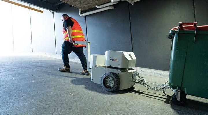 Powered Tug rise towing a 1100 litre bin up a ramp