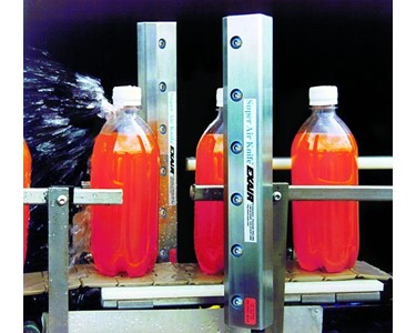 Bottles exiting a washer are blown dry by 2 x 12&quot; Super Air Knives prior to labelling.