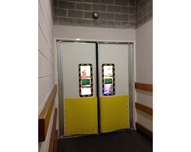 Traffic door with safety bumpers